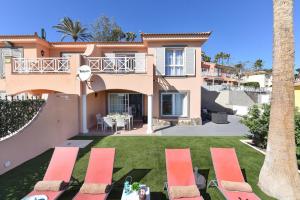 a villa with a lawn in front of a house at Chalet Santa Ana 2 by VillaGranCanaria in Playa del Ingles