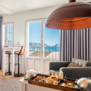 a living room with a view of the ocean at Porta Nova Suites Altea - Adults Only in Altea