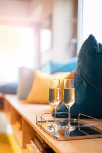 two glasses of wine sitting on a coffee table at Quality Hotel Carlia in Uddevalla