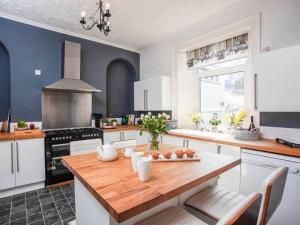 a kitchen with a wooden table in a room at Large House, sleeps 10 with incredible sea views in Ilfracombe +38 photos