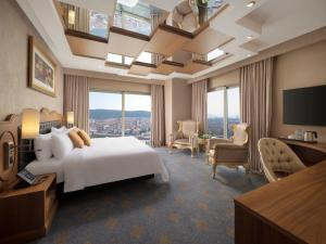 a hotel room with a bed and a large window at Selectum City Ataşehir in Istanbul