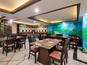 a restaurant with tables and chairs in a room at WEST COTTAS HOTEL -- Couples, Family, Corporate Favorite in Heart of Jalandhar in Jalandhar