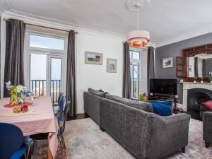 a living room with a couch and a table at Large House, sleeps 10 with incredible sea views in Ilfracombe