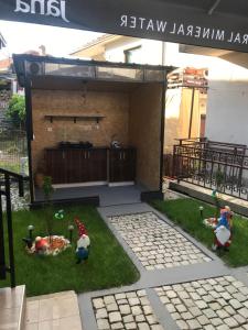 a miniature garden with toy figures in the grass at Apartmani Anja Ohrid in Ohrid