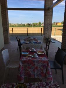 a table set up for a meal on a patio at B&B Casa Egle in Corbola
