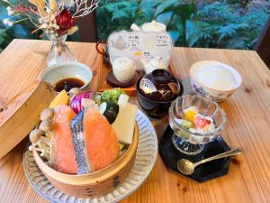 a table topped with a basket of sushi and other foods at Ikoi No Ie in Kyoto