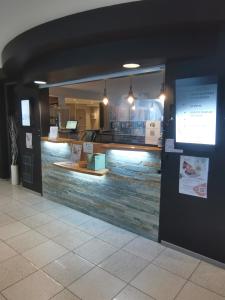 a store front with a counter in a building at Logis, Hôtel Au Chêne Vert, Saint-Brieuc Nord in Plérin