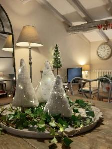 a group of christmas trees on a table at Cortona Shabby Chic House in Cortona