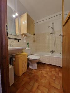 a bathroom with a toilet and a tub and a sink at Appartement - Vue Mont-Blanc in Cordon