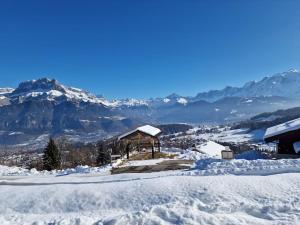 a snow covered mountain with a gazebo in the foreground at Appartement - Vue Mont-Blanc in Cordon