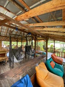 a living room with a long table and chairs at Tetebatu Sama Sama Bungalows in Tetebatu