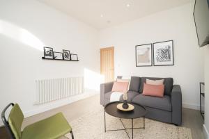 a living room with a couch and a table at Charlotte House, entire private house, close to city centre, WiFi in Sheffield