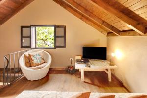 a room with a chair and a desk with a computer at The Perfect Cottage in São Vicente