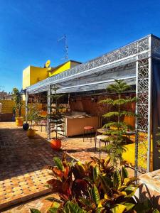 an outdoor area with a patio with plants at Riad Majorelle in Rabat