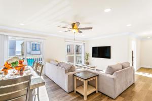 a living room with a couch and a table at Seashore Dreams B - Upper Unit in Newport Beach