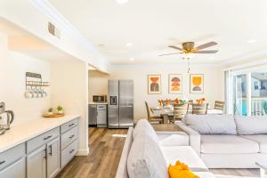 a living room with a white couch and a kitchen at Seashore Dreams B - Upper Unit in Newport Beach