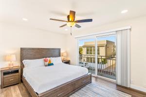 a bedroom with a bed and a large window at Seashore Dreams B - Upper Unit in Newport Beach