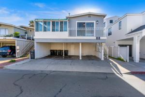 a large white house with a parking lot at Seashore Dreams B - Upper Unit in Newport Beach