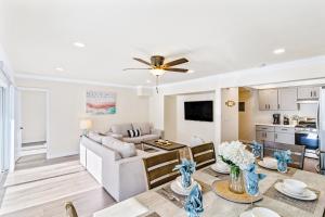 a living room with a couch and a table at 4912 Seashore A Lower in Newport Beach