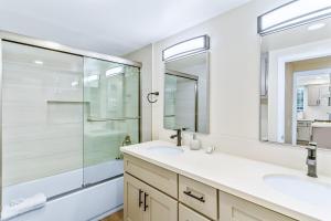 a bathroom with two sinks and a glass shower at 4912 Seashore A Lower in Newport Beach +16 photos