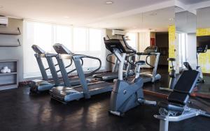a gym with a bunch of cardio equipment in it at Frontier Hotel Rivera in Rivera
