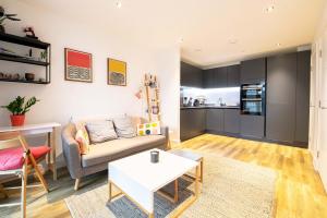 a living room with a couch and a table at Modern, Light-Filled Studio in Trendy North London in London