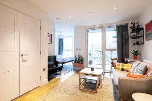 a living room with a couch and a table at Modern, Light-Filled Studio in Trendy North London in London