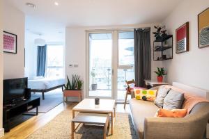 a living room with a couch and a tv at Modern, Light-Filled Studio in Trendy North London in London