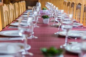 una mesa larga con platos y copas de vino. en San Anton Benasque, en Benasque