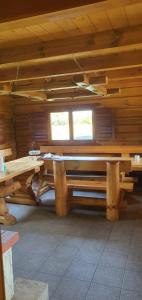 a log cabin with two tables and two windows at Drulenu sodyba 