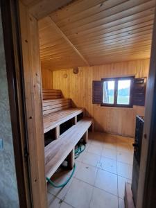 an inside view of a wooden sauna with a window at Drulenu sodyba in Drūlėnai