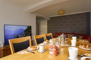 a dining room table with plates of food on it at Blue Sparrow House - parking in Portsmouth