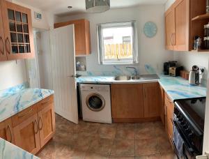a kitchen with a sink and a washing machine at So Tranquil in Charlestown