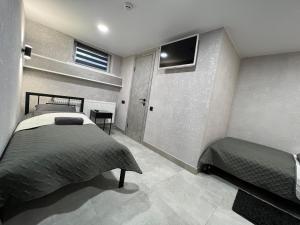 a bedroom with two beds and a flat screen tv at Avto Spa in Khmelʼnytsʼkyy