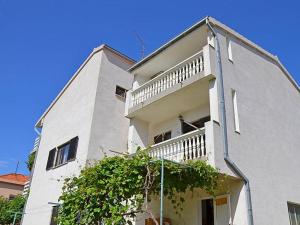 un alto edificio bianco con una scala sul lato di Apartments Zadro a Tribunj (Trebocconi) Altre 33 foto