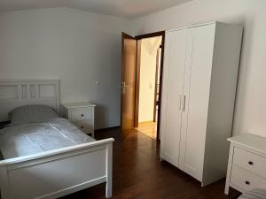 an empty bedroom with a bed and a closet at FeWo Köthen in Klepzig