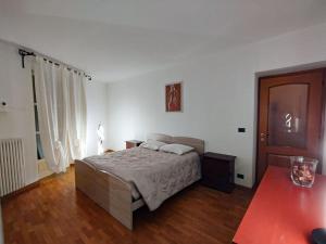 a bedroom with a bed and a wooden floor at La finestra sui Cappuccini in Turin