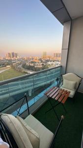 a balcony with a bench and a view of the city at 2 bedrooms new brand with amazing view in Ajman 