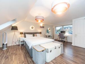 a bedroom with a large bed and a desk at Pass the Keys Beautiful Spacious Home in London