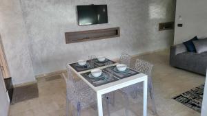 - un salon avec une table et des chaises blanches dans l'établissement Anfa Studio 1, à Casablanca