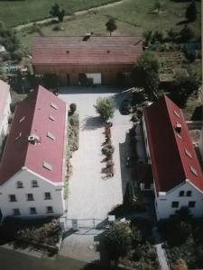 an aerial view of a building with a red roof at Ferienhof Gräfe - 3-Seiten Hof mit großem Garten, Pool & Sauna in Meißen