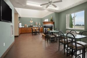 a dining room with a fireplace and tables and chairs at Four Seasons Inn in Bottineau