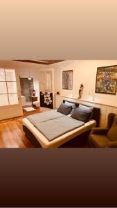 GoedereedeB&B Röderhaus Guesthouse Goedereede的带一张大床和一把椅子的卧室