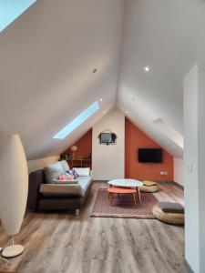 a living room with a couch and a table at Appartement calme Le clos de Renée in Hautvillers