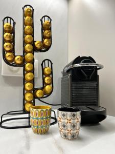 a sign that says love next to a microwave and two cups at Nouveau ! T2 neuf avec vue imprenable mer in Ajaccio