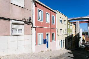 a group of buildings on the side of a street at St Amaro- Chic Terrace Studio Lisbon Congress in Lisbon