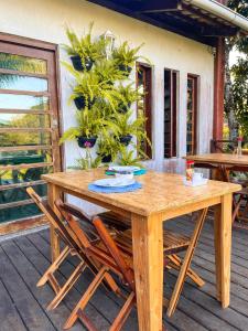una mesa de madera y sillas en una terraza en Pousada e Bistrô Estância Monte Horebe en Mulungu