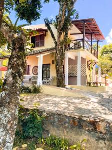 a house with two trees in front of it at Pousada e Bistrô Estância Monte Horebe in Mulungu +42 photos
