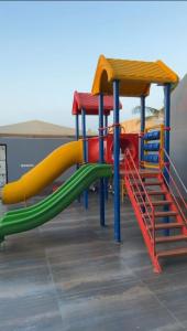 a playground with a slide in a building at فيلا بشاطي رملي خاص ومسبح عالبحر - درة العروس شاطي البردايس in Durat  Alarous