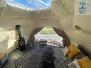 a teddy bear sitting inside of a tent at Glamping Dome Elysian Fields in Helston